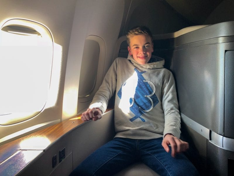 Boy in Cathay Pacific First Class Suite extra seat