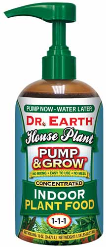 A close up of a bottle of Dr Earth Pump and Grow isolated on a white background.